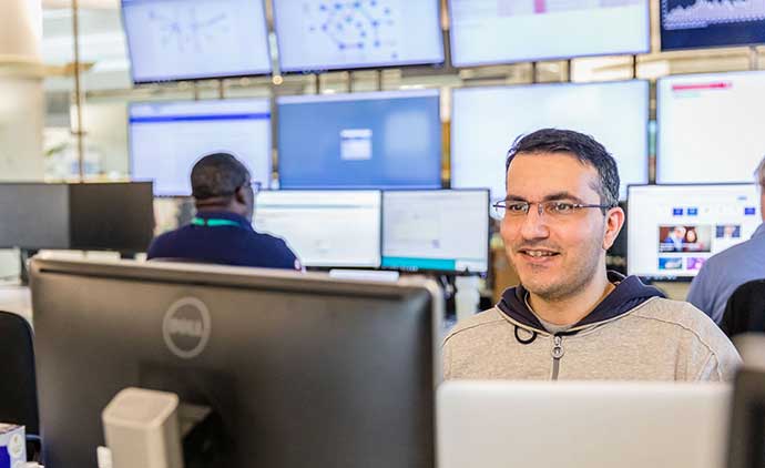 A man sitting looking at computer in an office